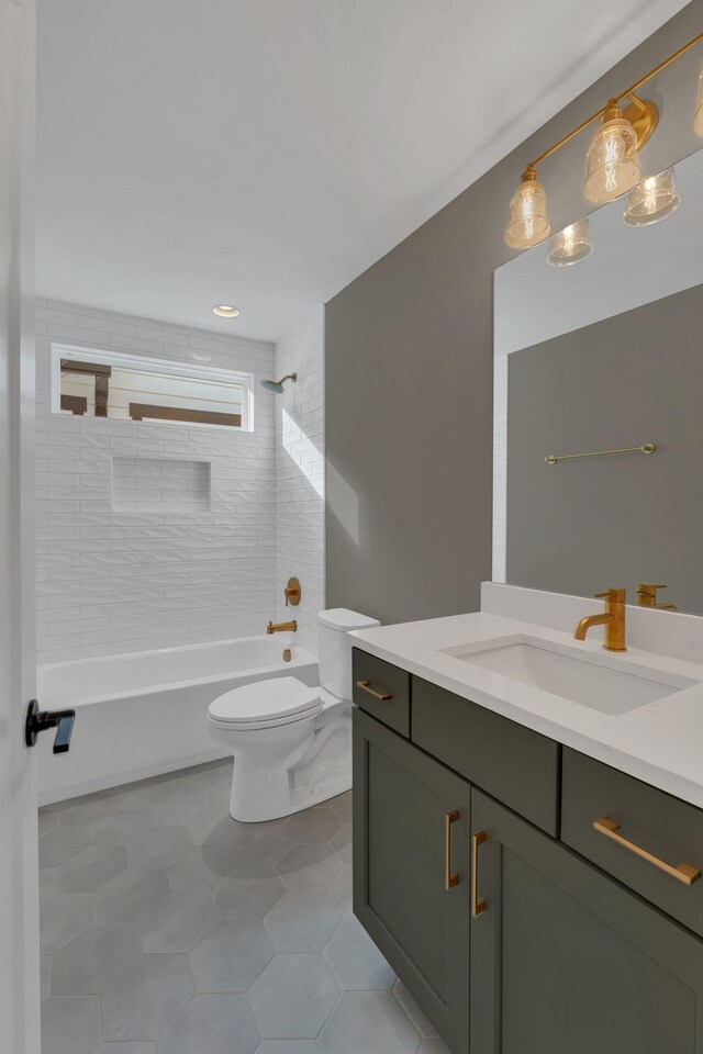 full bathroom with tile patterned flooring, vanity, toilet, and tiled shower / bath combo