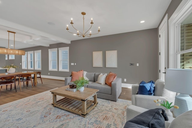 living room featuring beamed ceiling, hardwood / wood-style flooring, and a notable chandelier