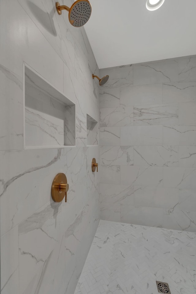 bathroom with a tile shower