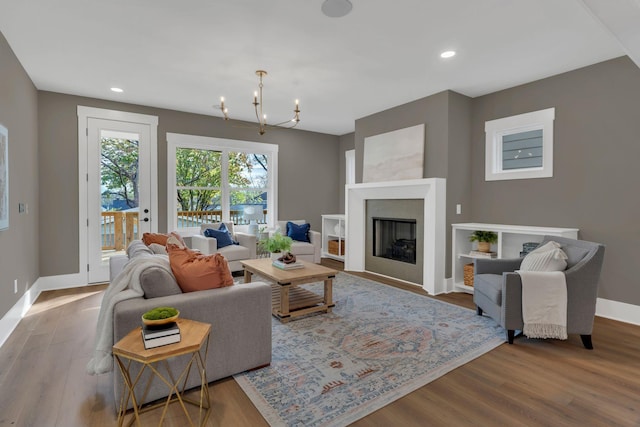 living room featuring hardwood / wood-style floors and an inviting chandelier