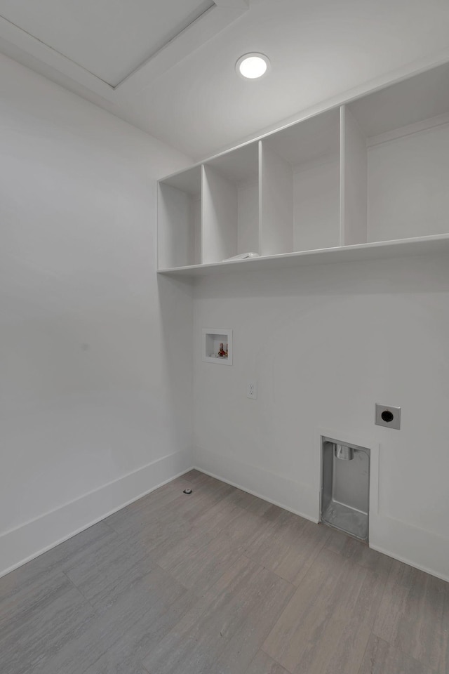 washroom with hardwood / wood-style flooring, electric dryer hookup, and hookup for a washing machine