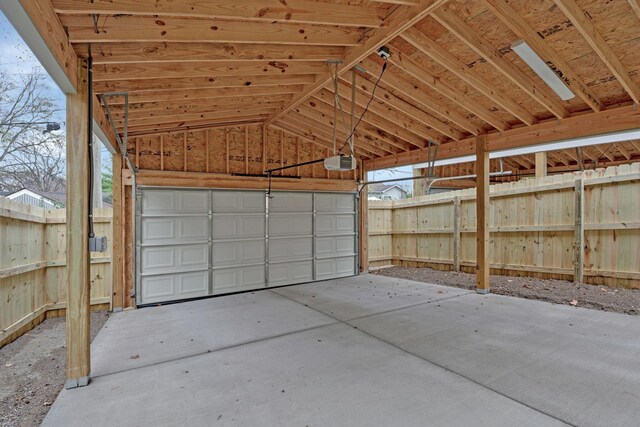 garage featuring a garage door opener and a carport