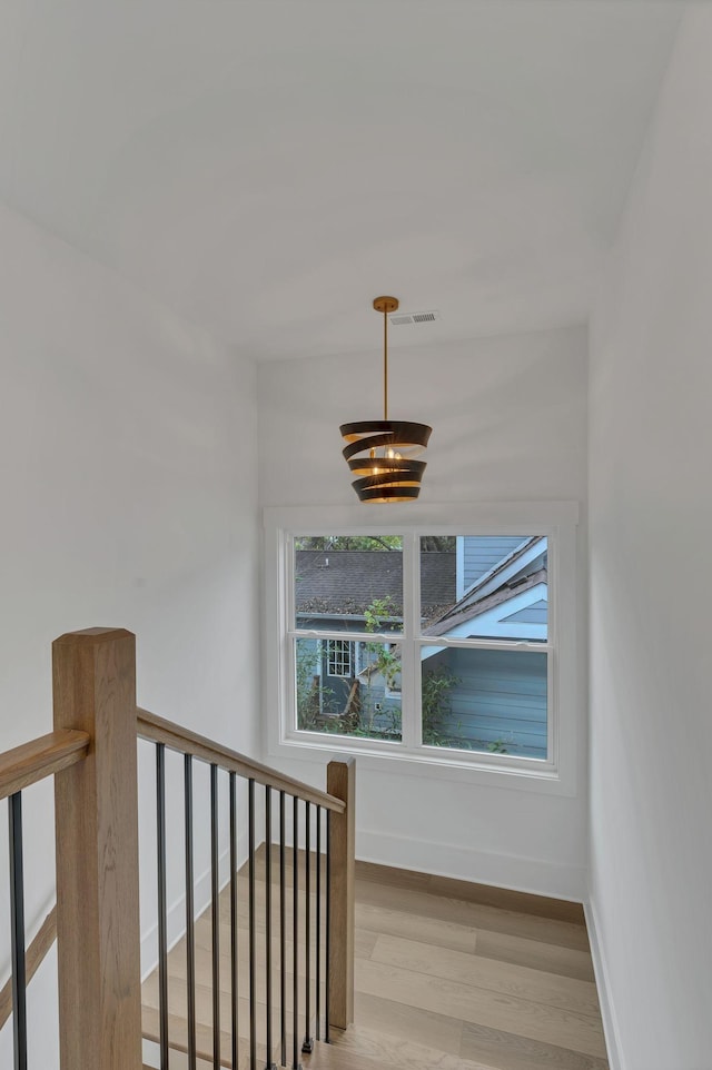 stairway featuring hardwood / wood-style floors