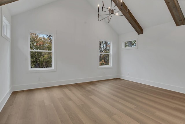 interior space with light hardwood / wood-style floors, beam ceiling, a healthy amount of sunlight, and high vaulted ceiling