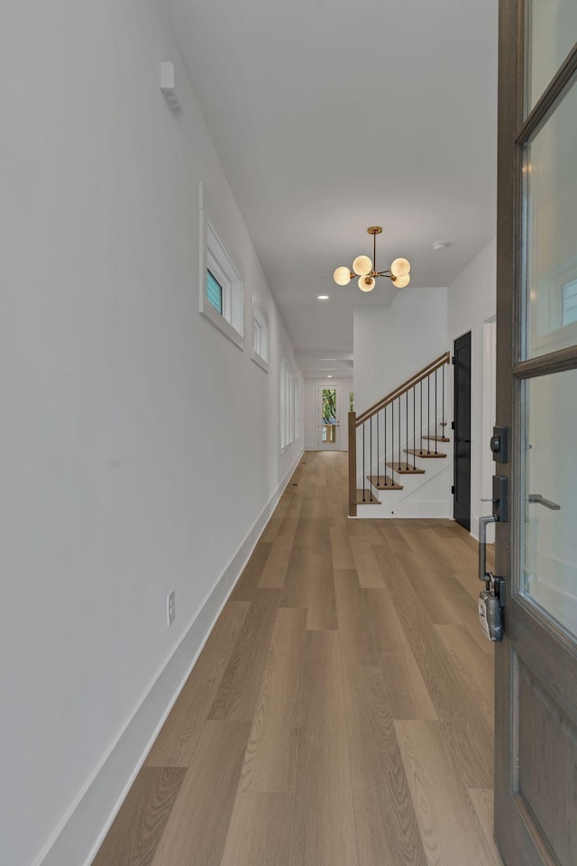 corridor with hardwood / wood-style floors