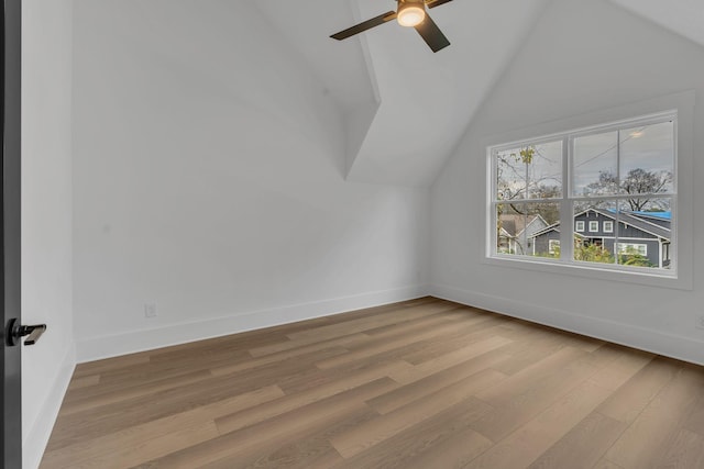 additional living space with light wood-type flooring, vaulted ceiling, and ceiling fan