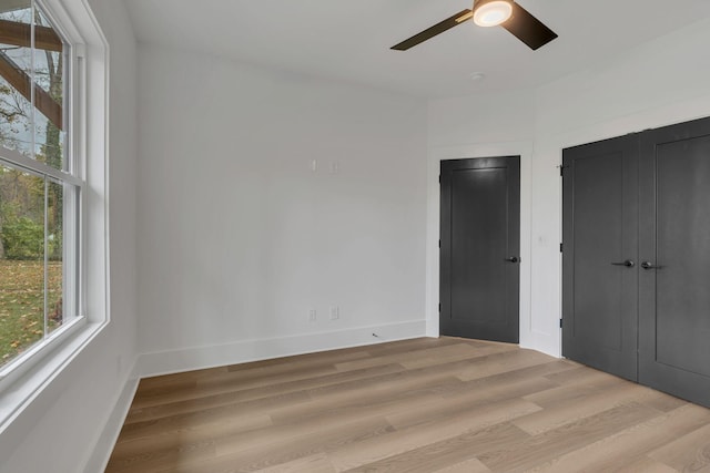 unfurnished bedroom with ceiling fan and light hardwood / wood-style floors