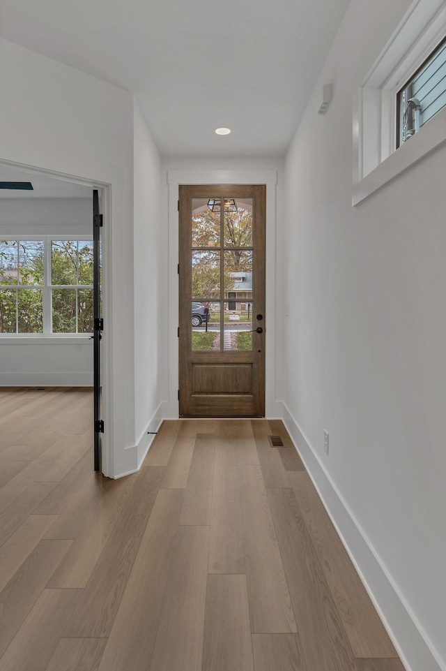 doorway to outside with light wood-type flooring