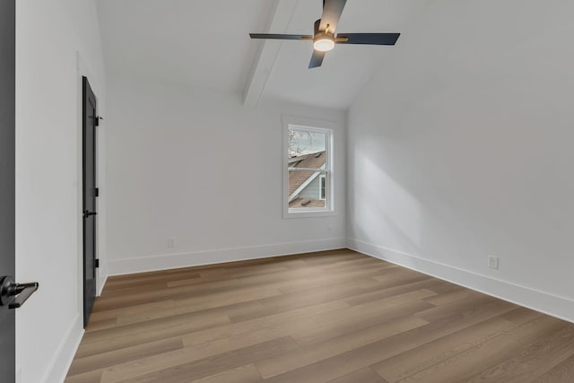 empty room featuring vaulted ceiling with beams, ceiling fan, and light wood-type flooring