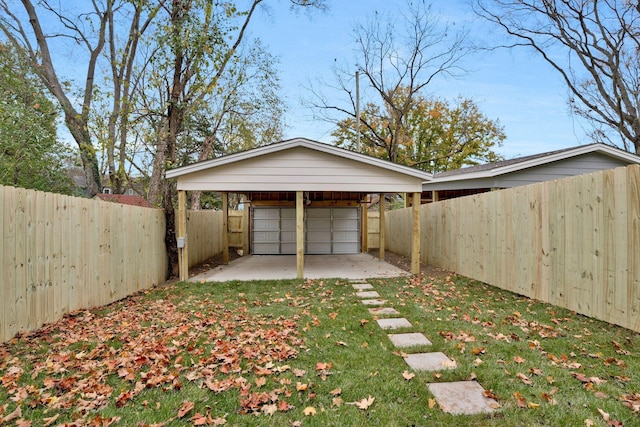 garage with a carport and a yard