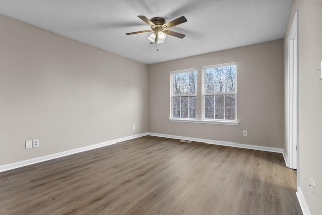 unfurnished room with wood-type flooring, a textured ceiling, and ceiling fan