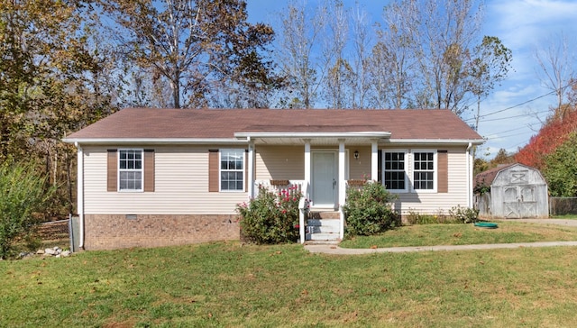 view of front of property with a storage unit and a front lawn