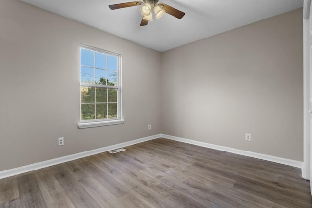 empty room featuring hardwood / wood-style floors and ceiling fan