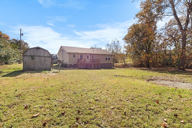 view of yard with a wooden deck and a storage shed