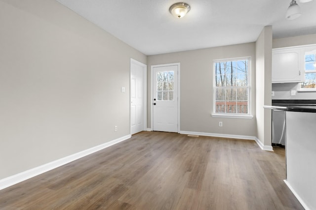 unfurnished dining area featuring wood-type flooring