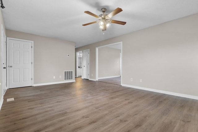 empty room featuring dark hardwood / wood-style flooring and ceiling fan