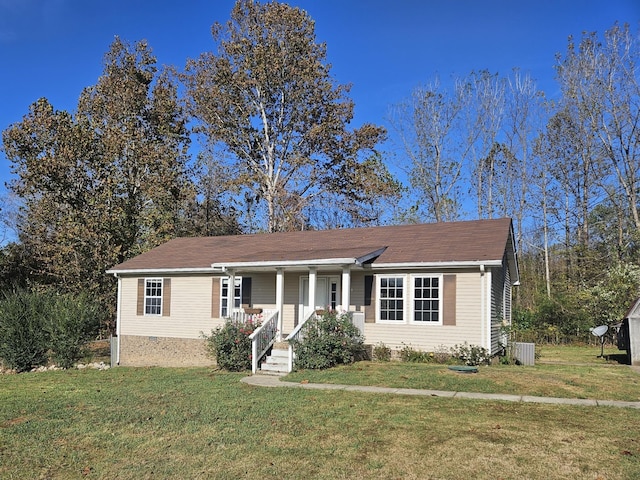 single story home featuring central air condition unit, a front lawn, and covered porch