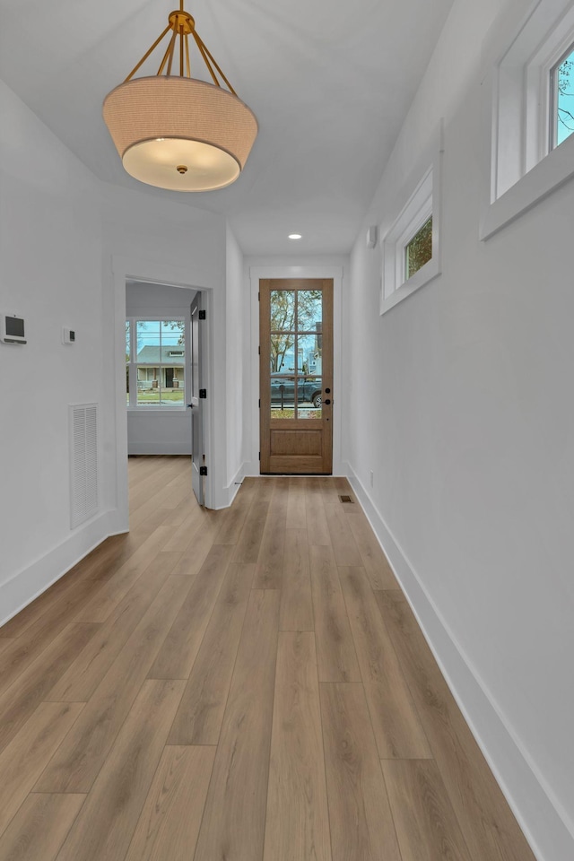 hallway with light wood-type flooring