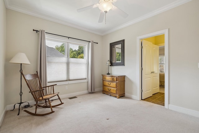 sitting room featuring crown molding, light colored carpet, and ceiling fan