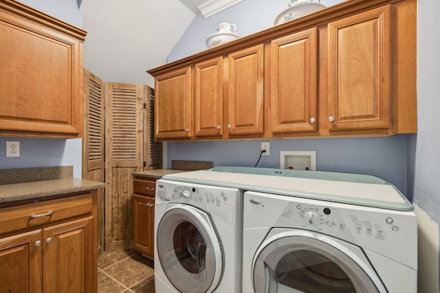 laundry area with independent washer and dryer and cabinets