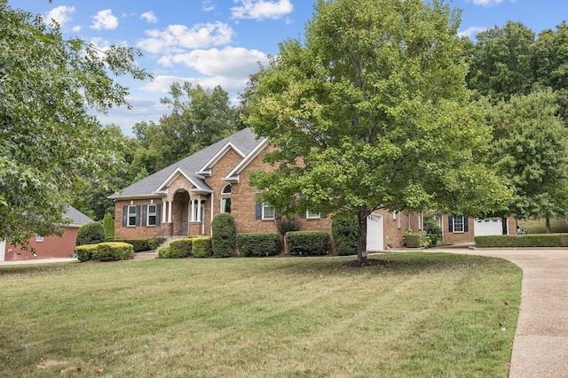 view of front of property with a garage and a front yard