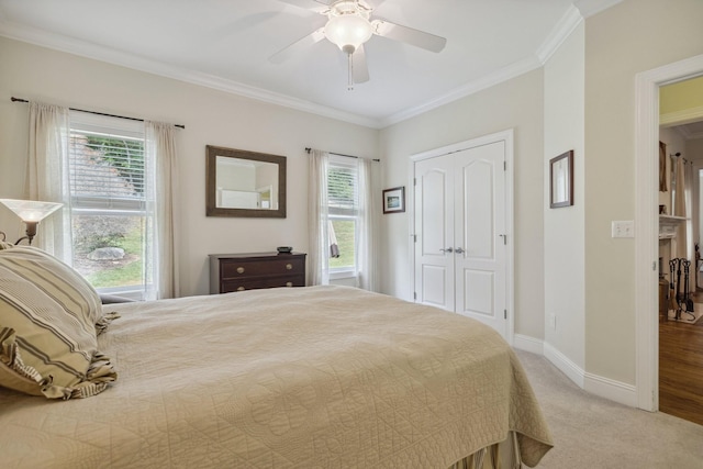 carpeted bedroom with multiple windows, ornamental molding, and ceiling fan