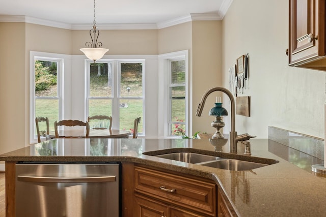 kitchen with sink, dark stone countertops, hanging light fixtures, ornamental molding, and stainless steel dishwasher