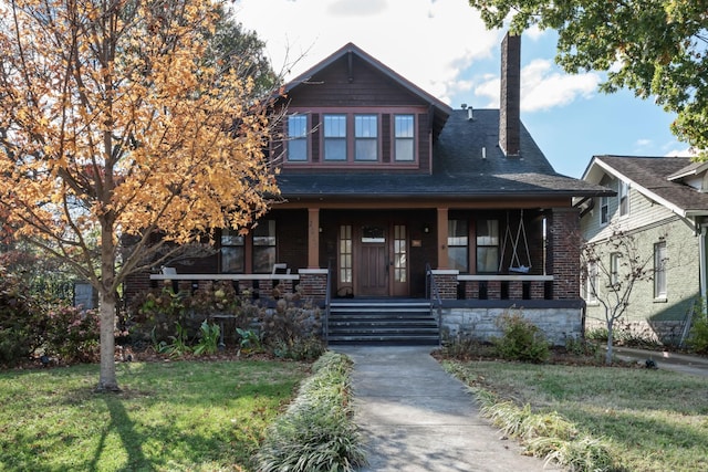 view of front facade with covered porch and a front yard