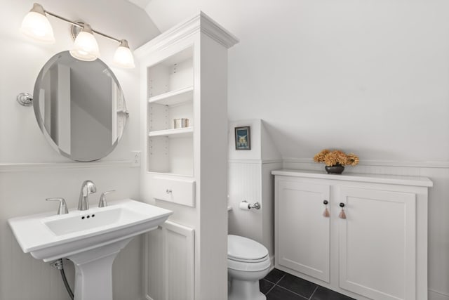 bathroom featuring sink, tile patterned flooring, vaulted ceiling, and toilet