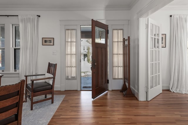 foyer featuring dark hardwood / wood-style flooring and ornamental molding