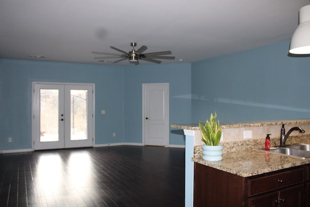 living room with french doors, ceiling fan, dark wood-type flooring, and sink