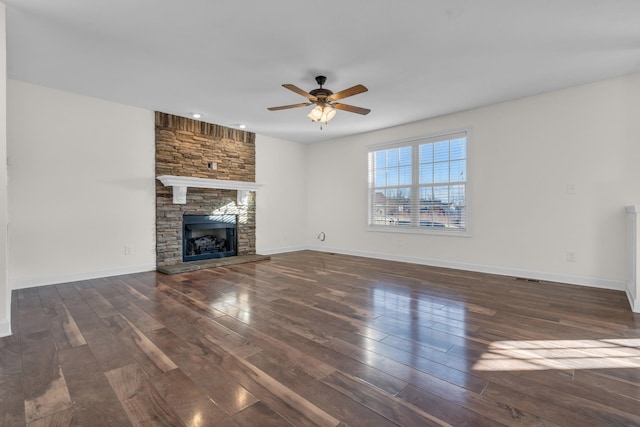 unfurnished living room with ceiling fan, dark hardwood / wood-style floors, and a fireplace