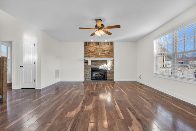 unfurnished living room featuring ceiling fan, dark hardwood / wood-style floors, and a fireplace