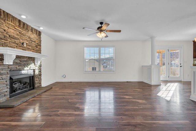 unfurnished living room featuring ceiling fan, dark hardwood / wood-style floors, and a fireplace