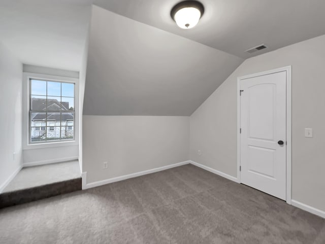 bonus room featuring carpet flooring and vaulted ceiling