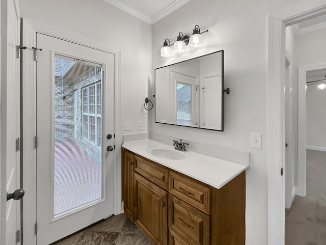 bathroom with crown molding, vanity, and ceiling fan