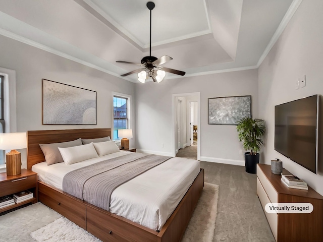 carpeted bedroom featuring a tray ceiling, ceiling fan, and ornamental molding