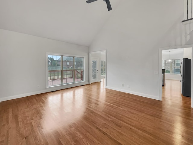 unfurnished living room featuring ceiling fan, hardwood / wood-style floors, and high vaulted ceiling