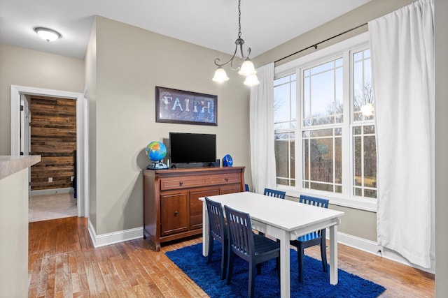 dining room featuring hardwood / wood-style flooring and an inviting chandelier