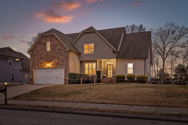 front of property featuring a yard and a garage