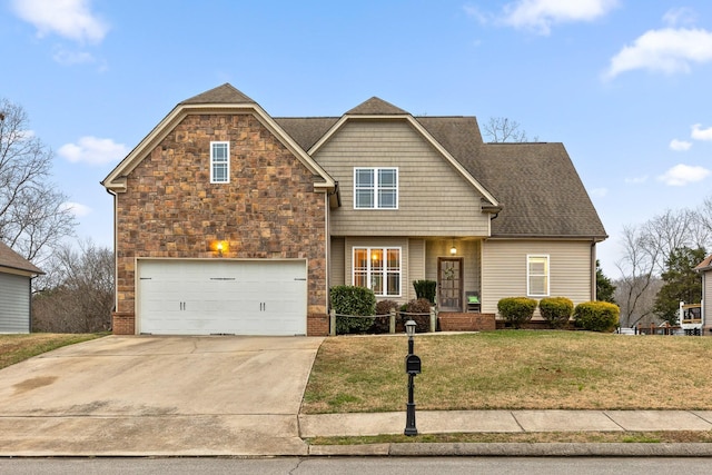 view of front of home featuring a front yard and a garage