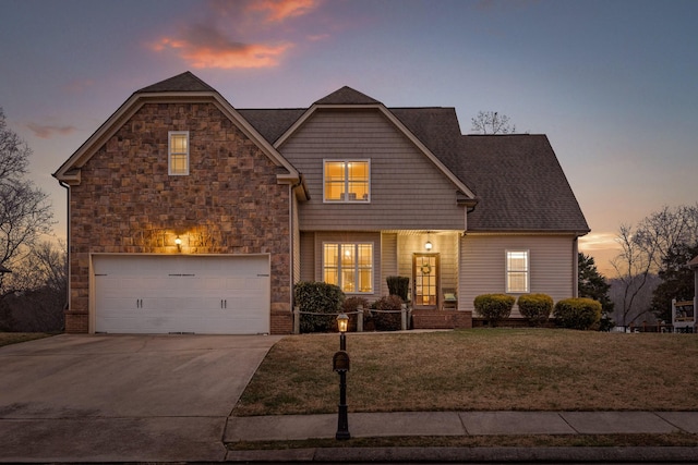 front facade featuring a garage and a lawn