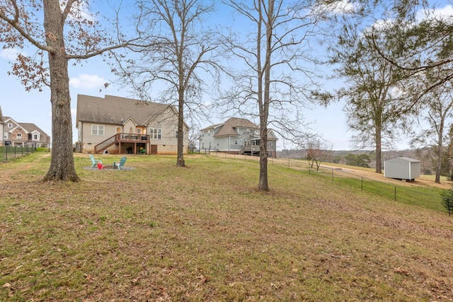 view of yard featuring a storage unit and a deck