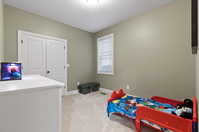 carpeted bedroom featuring a closet