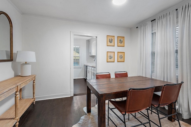 dining space with dark hardwood / wood-style floors and crown molding