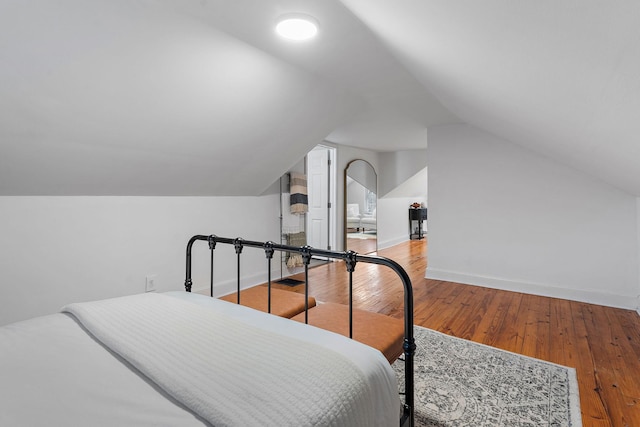 bedroom with hardwood / wood-style flooring and vaulted ceiling