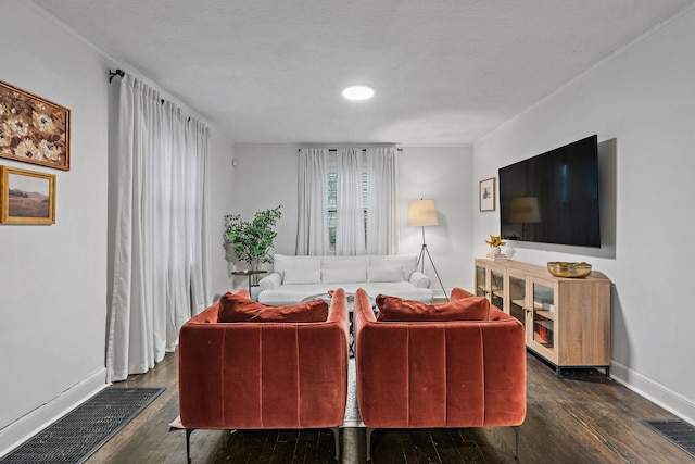 living room featuring dark hardwood / wood-style floors and a textured ceiling