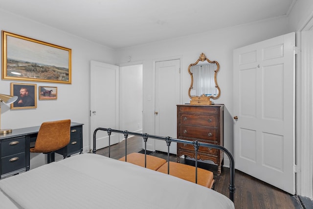 bedroom with crown molding and dark wood-type flooring