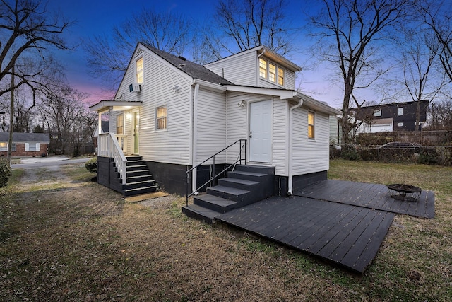 back house at dusk with a fire pit