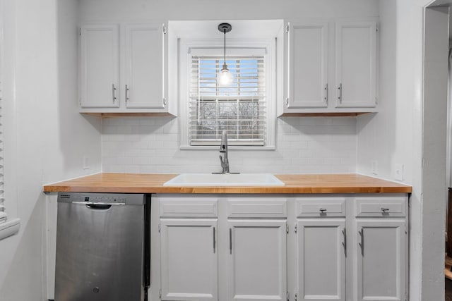 kitchen with white cabinets, sink, backsplash, hanging light fixtures, and stainless steel dishwasher